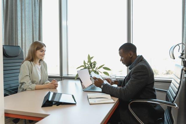 Accounting job interview showing a young woman interviewed by older man 