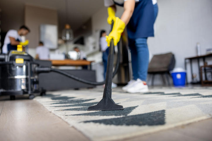 person vacuuming carpet