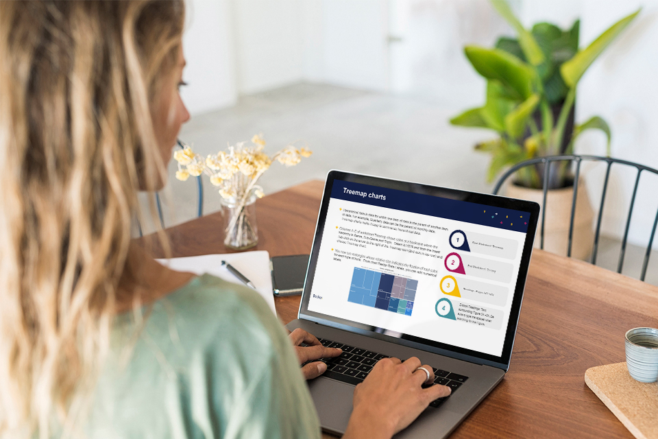 A woman looking at a computer on a table