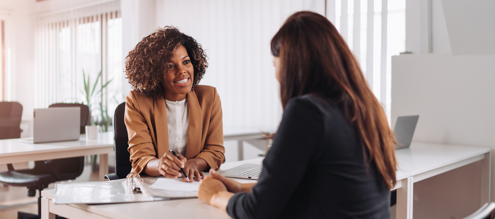 two women meeting at a bank 