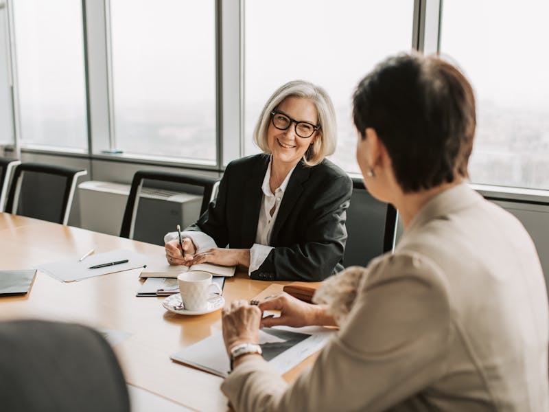 Enrolled agent vs CPA two women in business meeting  