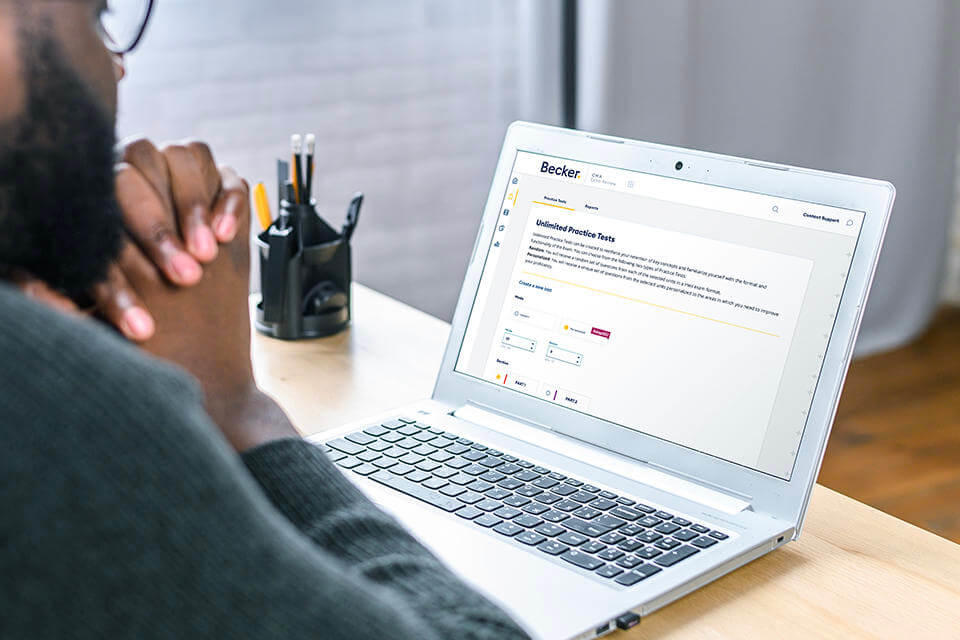 CMA student studying for test on laptop