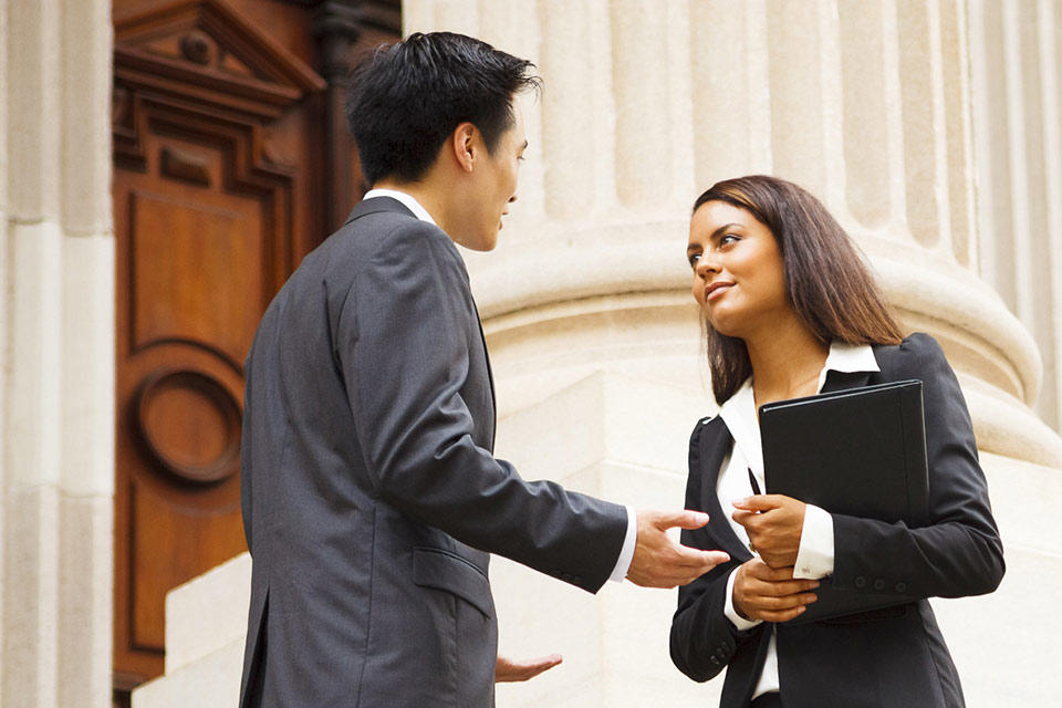 Professional woman man talking on stairs of government building