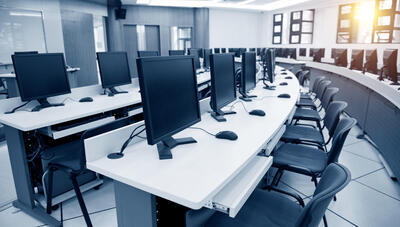 computers on desks in an open plan office