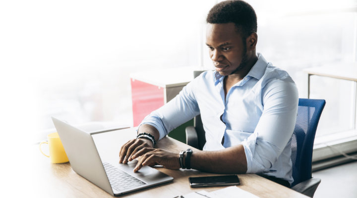 Man working on a laptop in an high rise office
