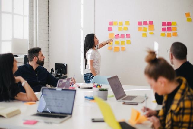 group of professionals brainstorming on a white board