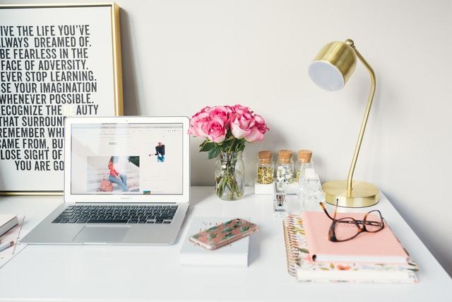 desk with flowers and laptop