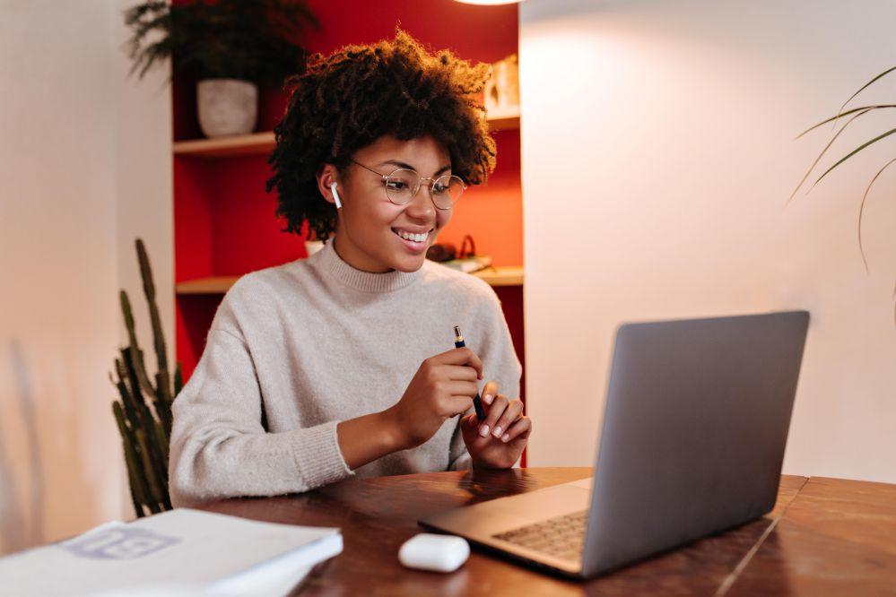 woman using a stylus at a laptop