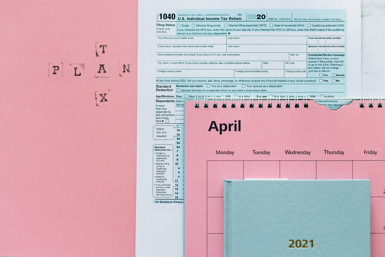 April calendar on top of 1040 Tax form