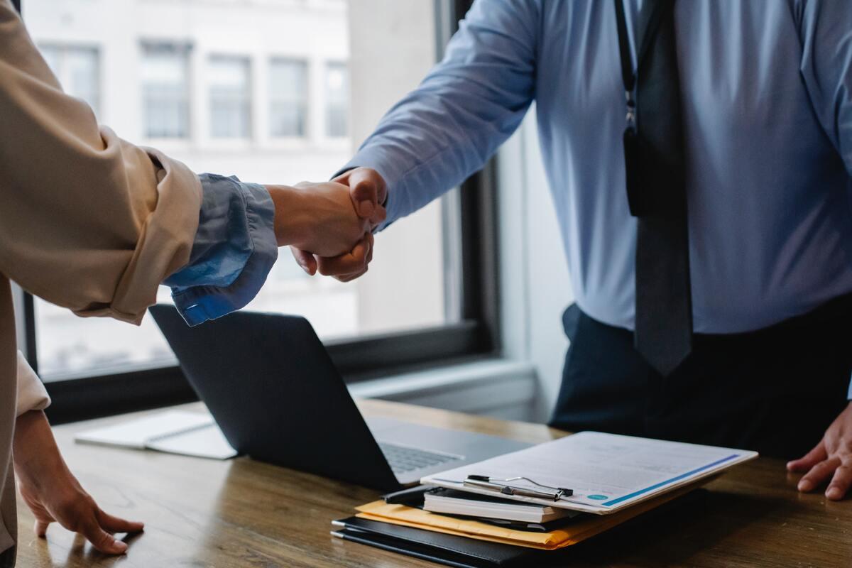 Woman and man in office shaking hands