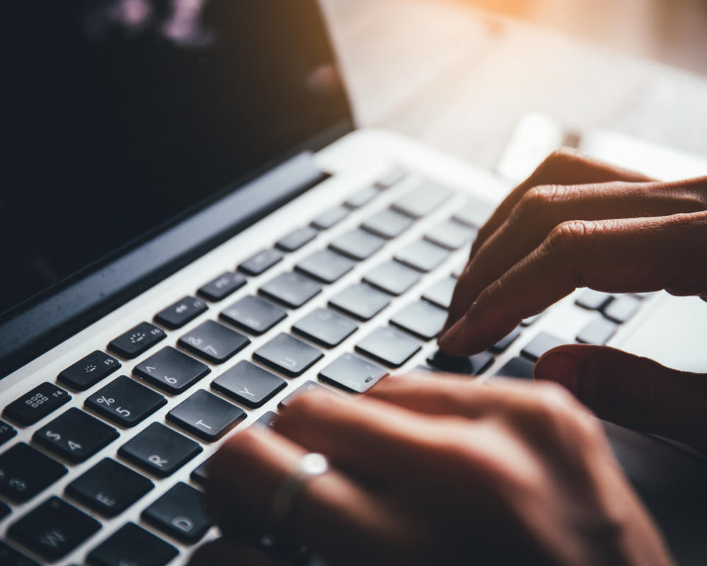 person typing on a laptop