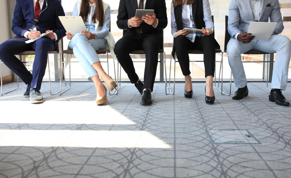 five professionals sitting in a waiting area