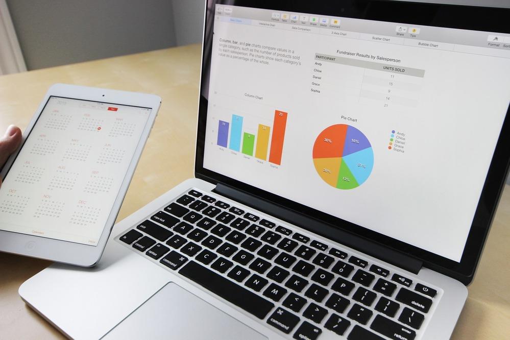 spreadsheet and graphs on laptop and ipad