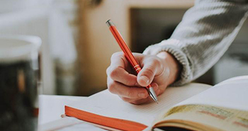 A student writing down notes