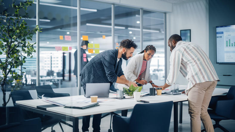 three colleagues working on a conference table