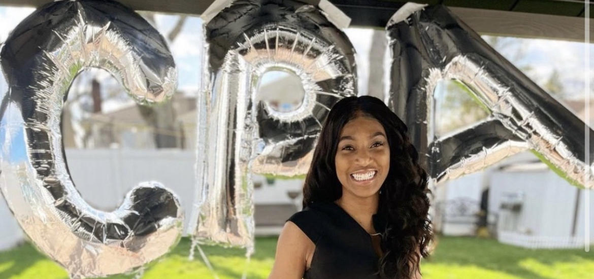 person posing with CPA balloons