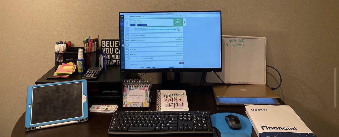 desk with computer ipad and textbook