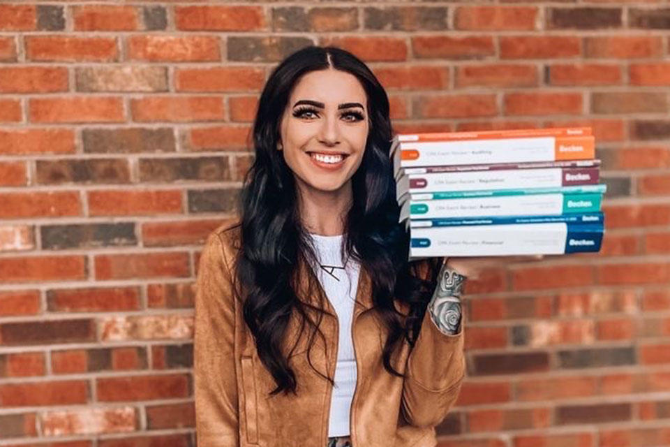 CPA Student with stack of Becker textbooks
