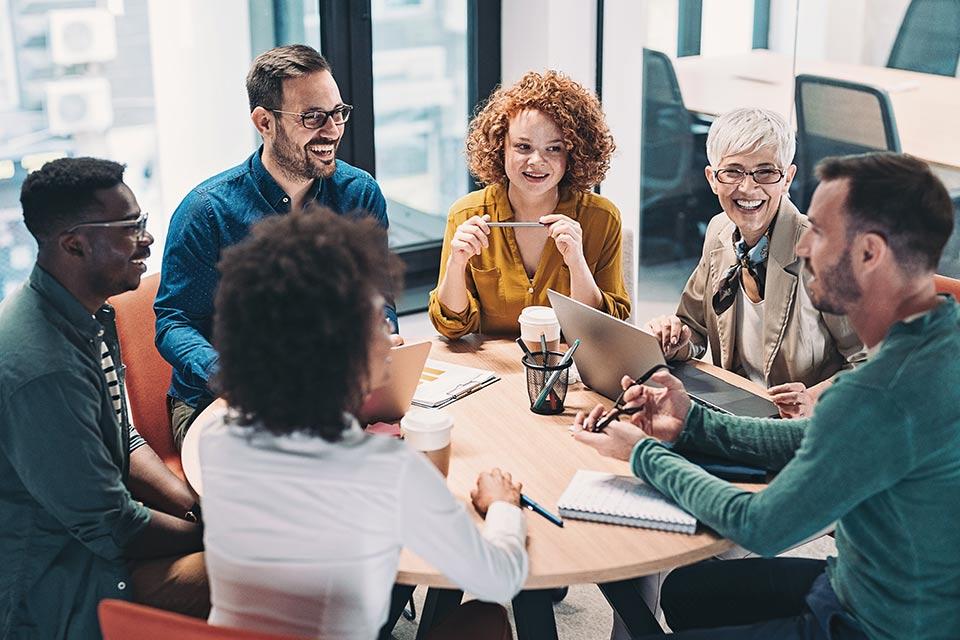 Group meeting in conference room with diverse group of professionals