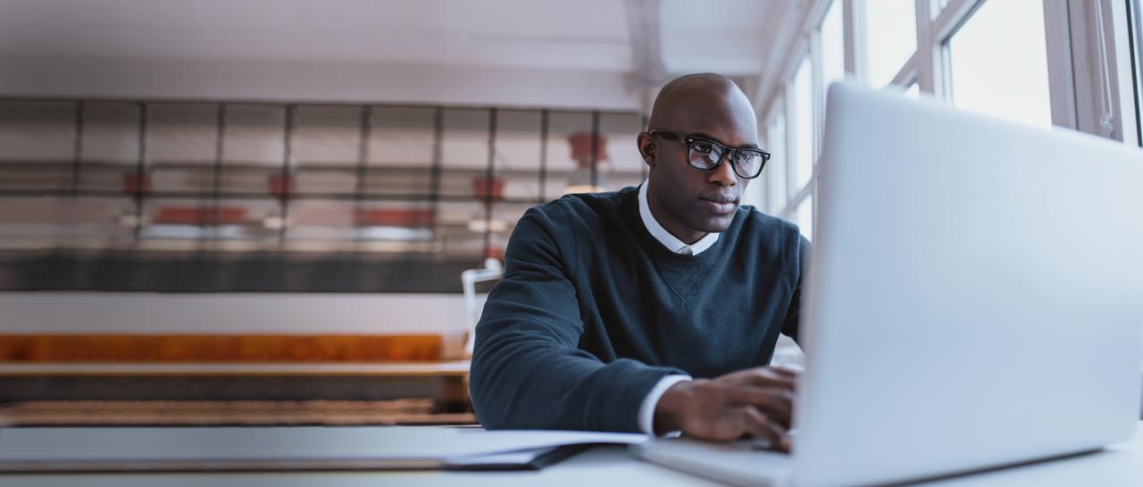 man looking at laptop to learn cpa salary