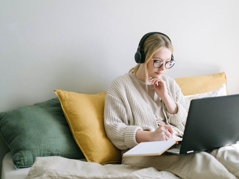 Young woman in white sweater studying for the FAR CPA Exam
