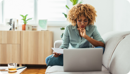 Woman studying at laptop on couch