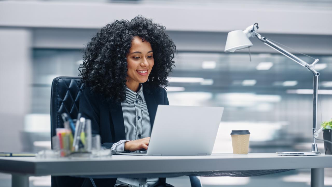 woman working at laptop in office setting
