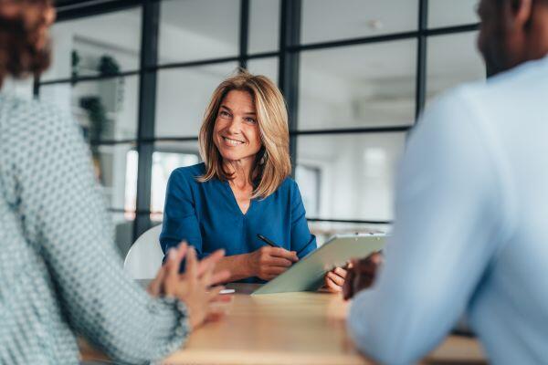 Mid-career female accounting professional speaking to clients 
