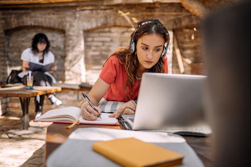 Young woman studying for the CPA Exam on a laptop