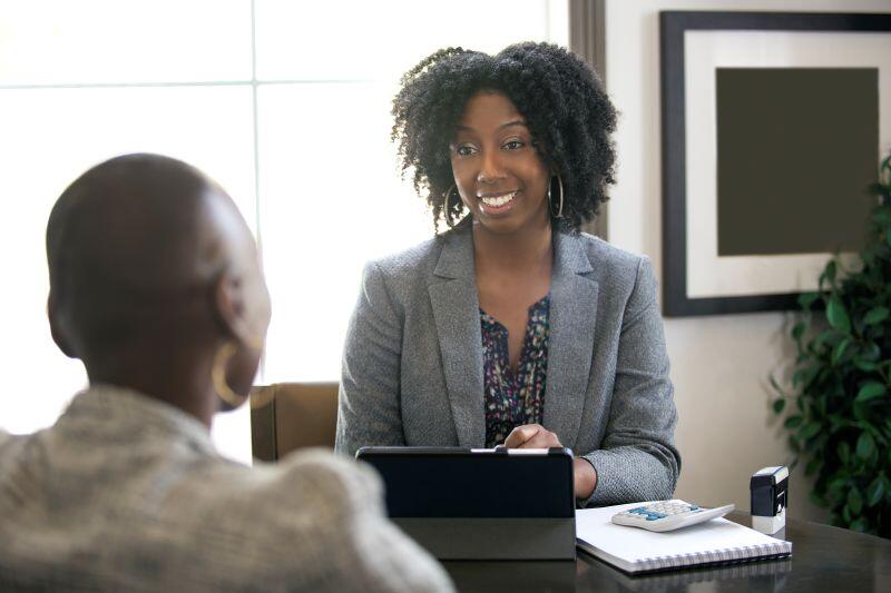 Black female tax preparer works with a client while practicing what's outlined in Circular 230