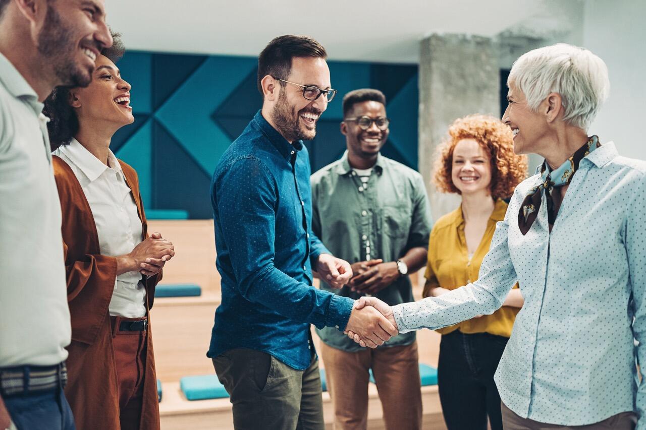 group of people with 2 shaking hands