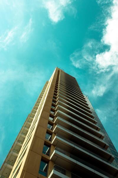 A picture of a skyscraper from the bottom looking up