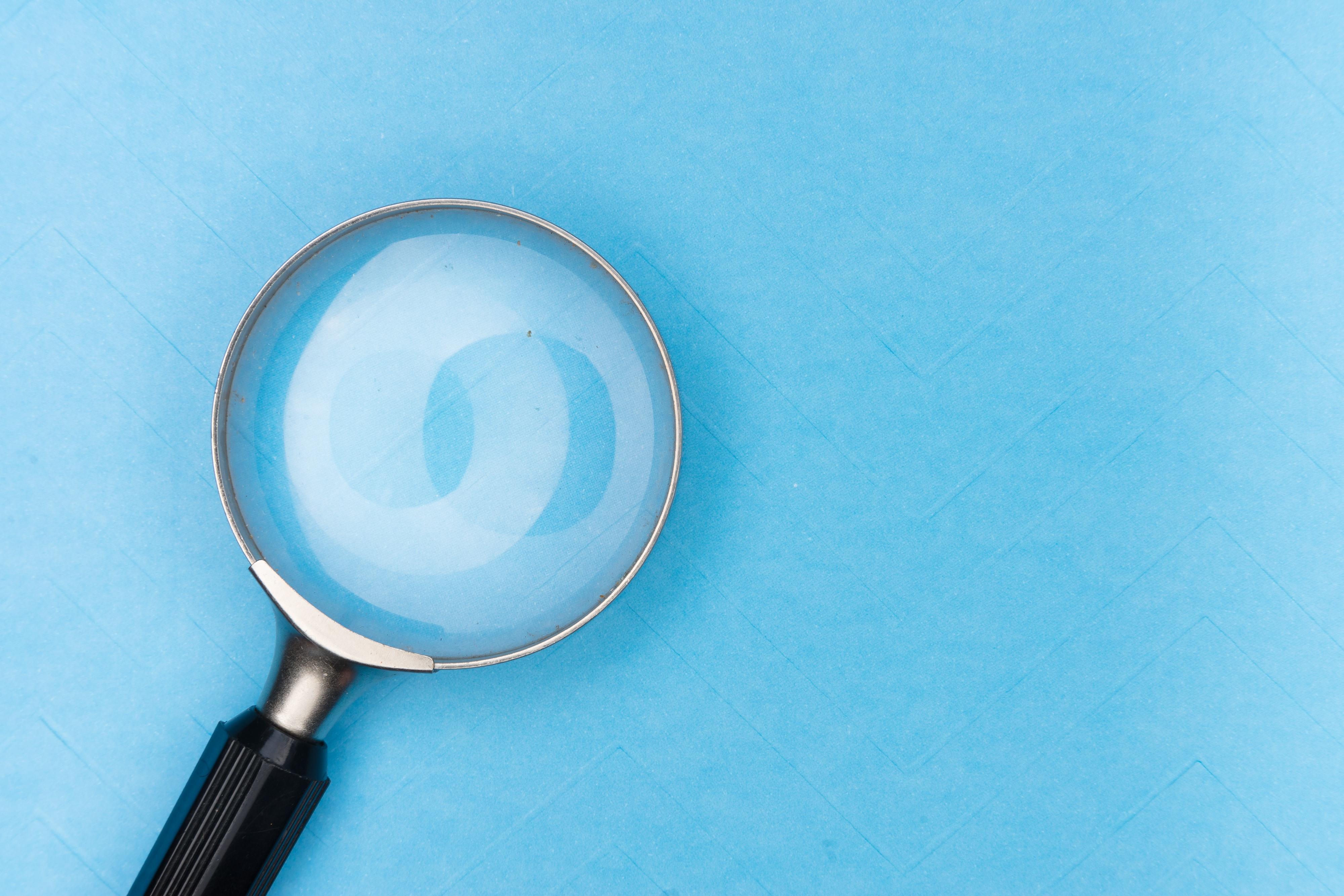 magnifying glass on a blue page