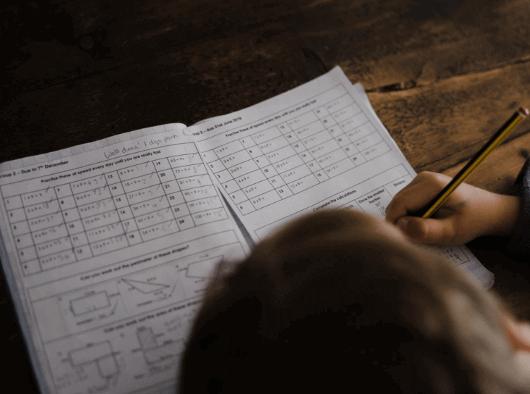 Person working on accounting sheets